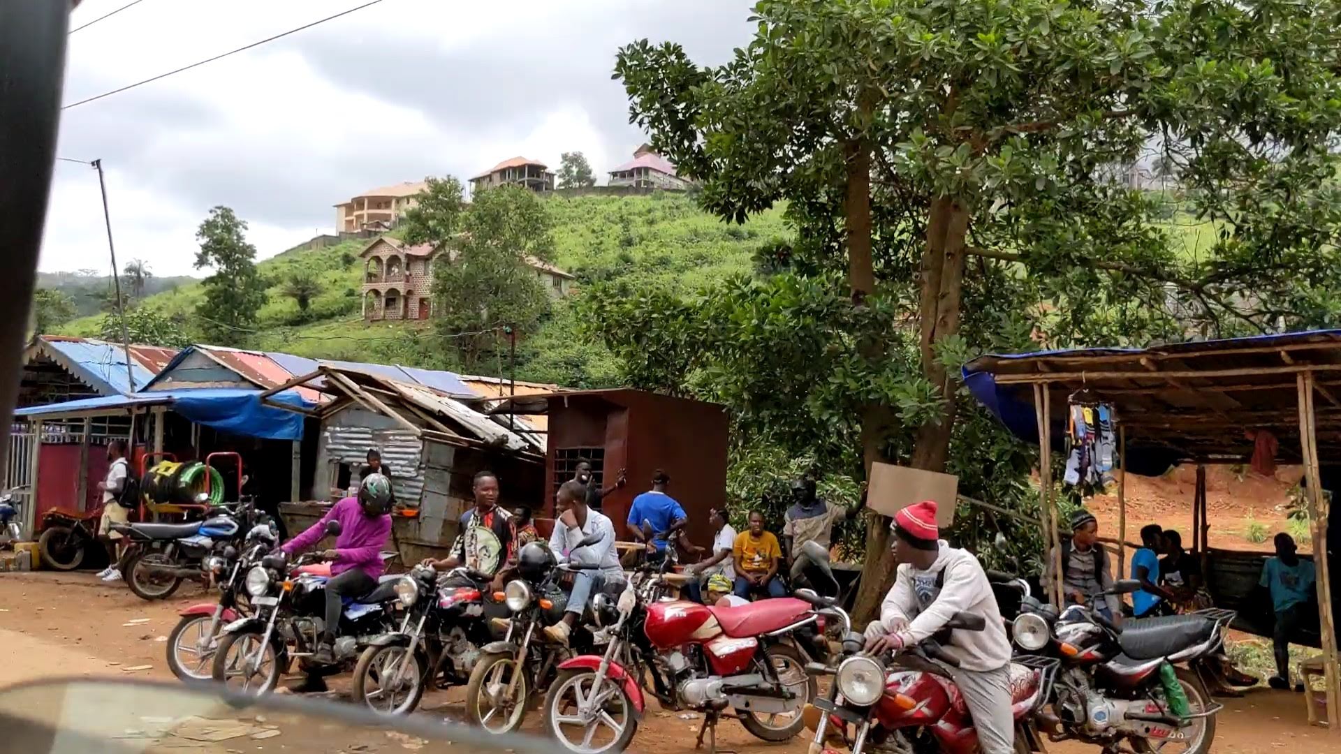 Men on motorcycles waiting to give people rides.